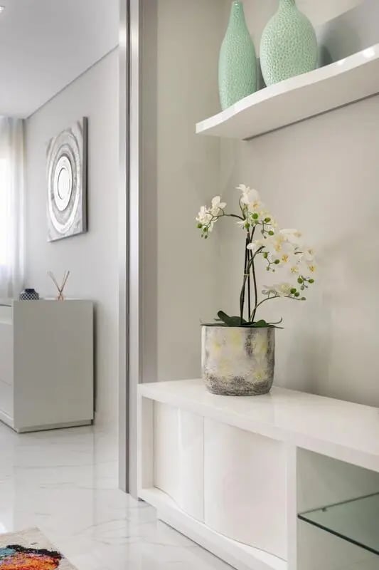White orchid plant white cabinet white shelf vases hall at Modern flat in Vilamoura near the beach and marina in Vilamoura Student Accommodation