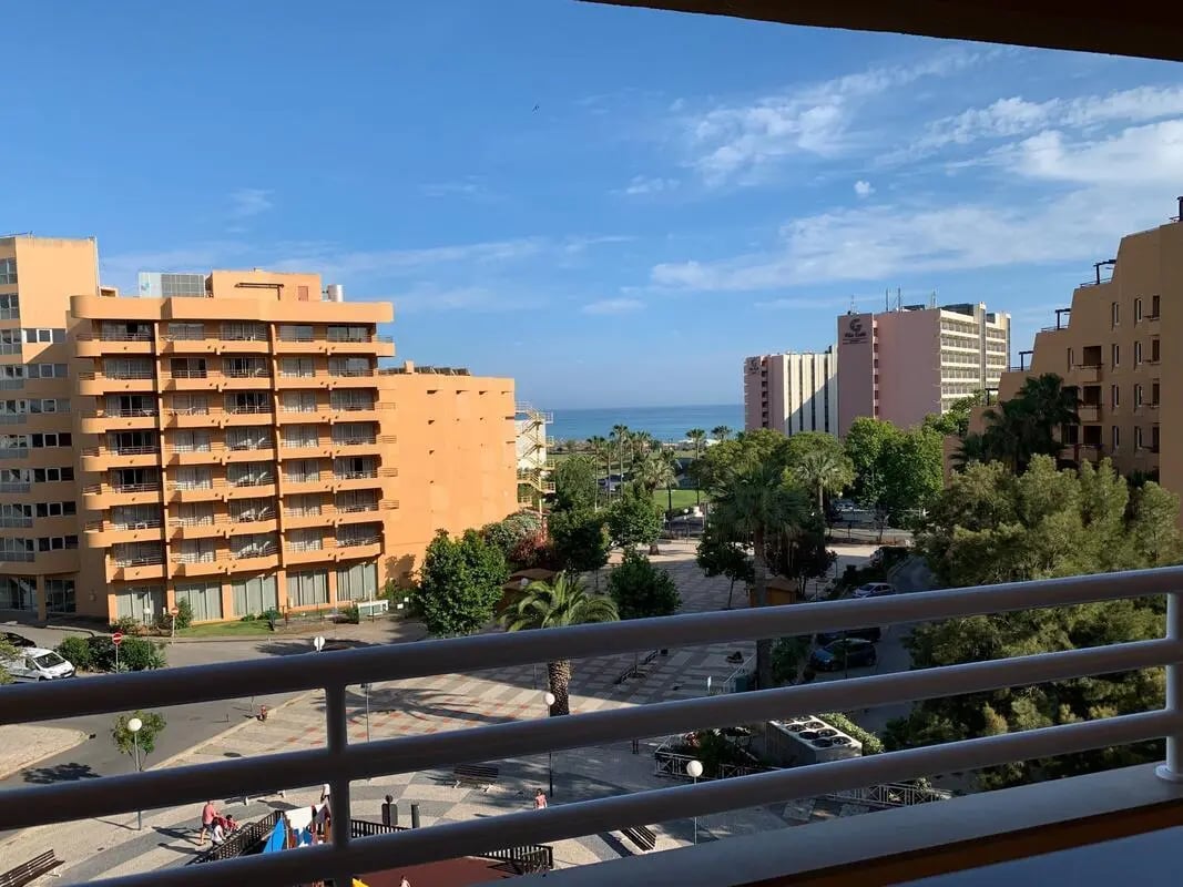 Orange buildings and palm trees exterior at Spacious 1-bedroom apartment in Vilamoura in Vilamoura Student Accommodation