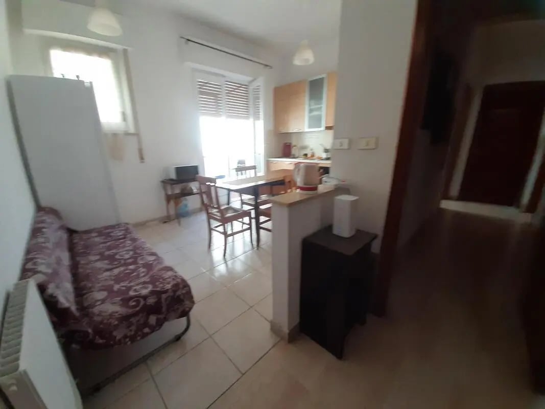 Sofa table and chairs kitchen area living room at Double bedroom, with balcony, in 4-bedroom apartment in Reggio Calabria Student Accommodation