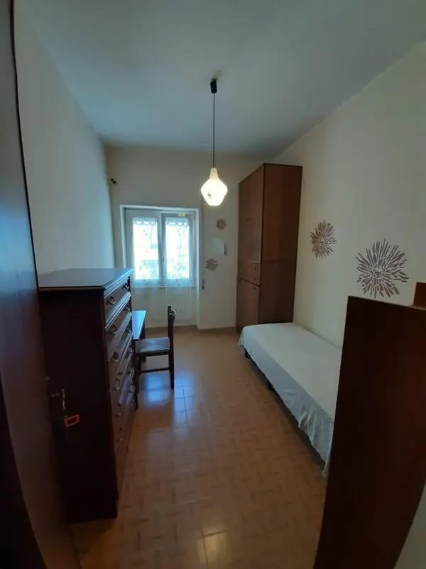 Wardrobe dresser bed chair window bedroom at Double bedroom in 4-bedroom apartment in Reggio Calabria Student Accommodation
