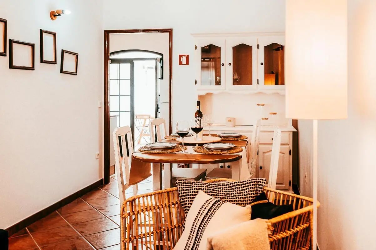 Dining table with place settings and chairs living room at Welcoming 2 Bedroom House with outside area close to Alagoa Beach in Altura Student Accommodation