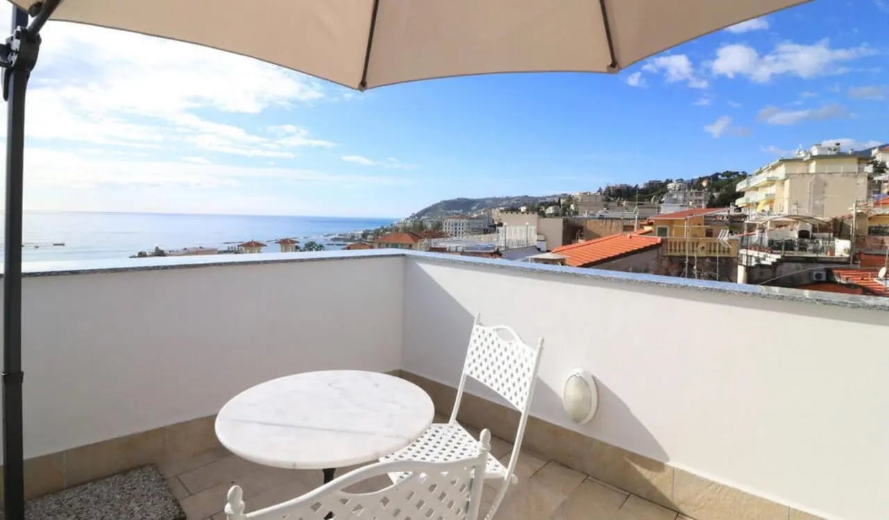 Balcony with table chairs overlooking town exterior at Welcoming studio in the centre of Sanremo in Sanremo Student Accommodation