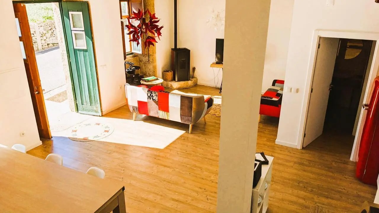 Patchwork sofa wood floor doors living room at 2-bedroom house in Castelo Branco Student Accommodation
