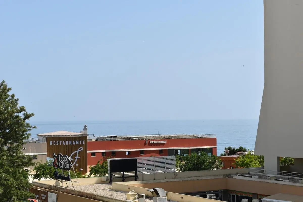 Buildings and ocean view exterior at Beautiful 1-bedroom apartment near Praia da Rocha in Portimão Student Accommodation