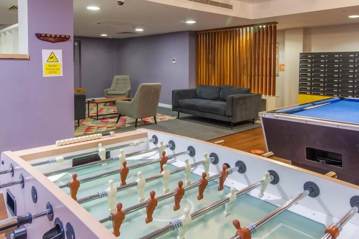Foosball table billiard table sofas chairs lounge area at Bowman House in Nottingham Student Accommodation