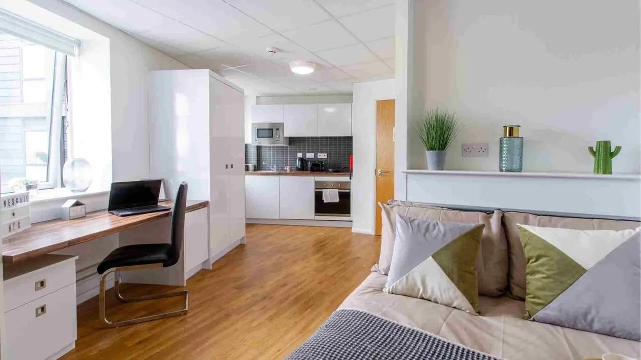 Desk laptop chair kitchen and bed studio apartment at Danesgate House in Lincoln Student Accommodation