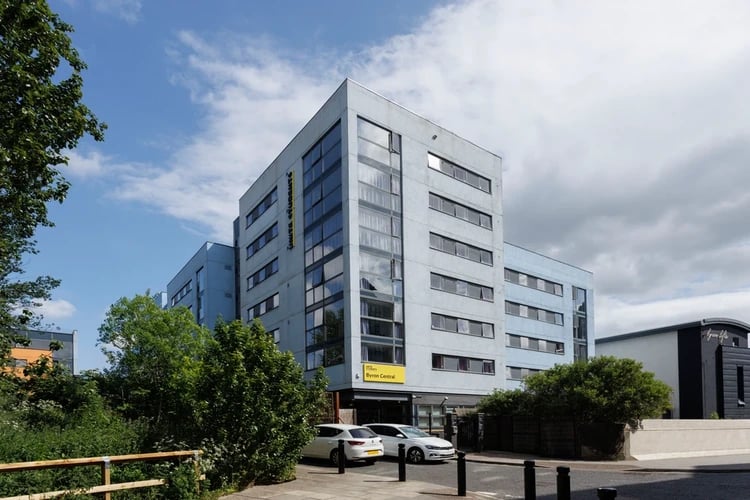 Modern blue student building cars and trees exterior at Byron Central in Newcastle Upon Tyne Student Accommodation
