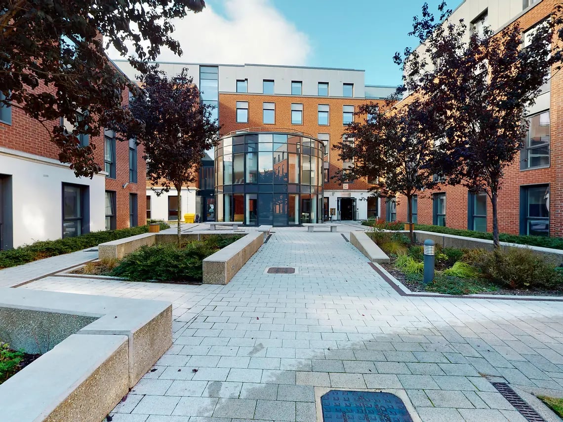 Modern brick building with glass entrance exterior at Canterbury Student Manor in Canterbury Student Accommodation