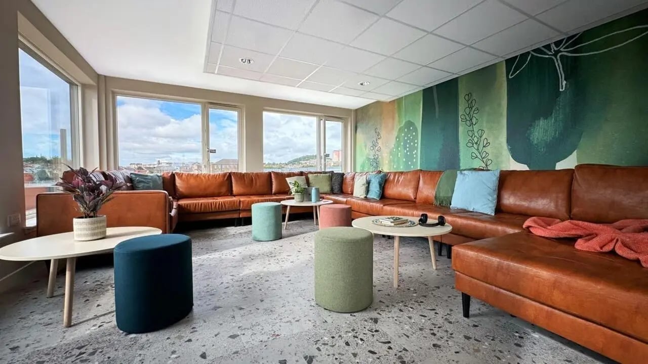 Brown sectional sofa with colorful ottomans and tables living room at Parklands in Dundee Student Accommodation