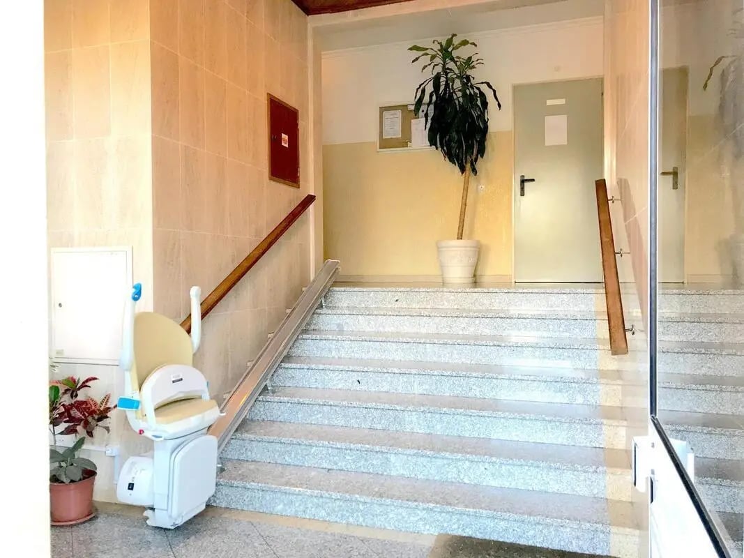 Stairlift, plant, doors, and stairs Interior hallway at Fascinating 2 Bedroom Apartment close to University of the Algarve in Faro Student Accommodation