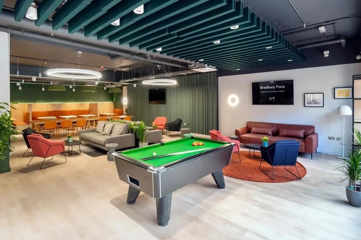 Pool table sofas lounge area seating dining area common room at Bradbury Place in Belfast Student Accommodation