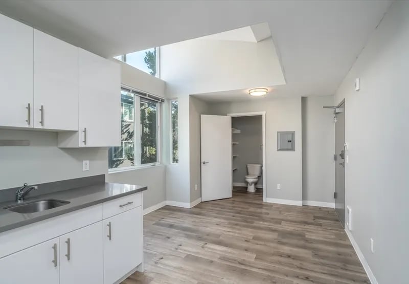 Kitchen with white cabinets sink toilet visible Bathroom at Ace Apartments in Seattle Student Accommodation