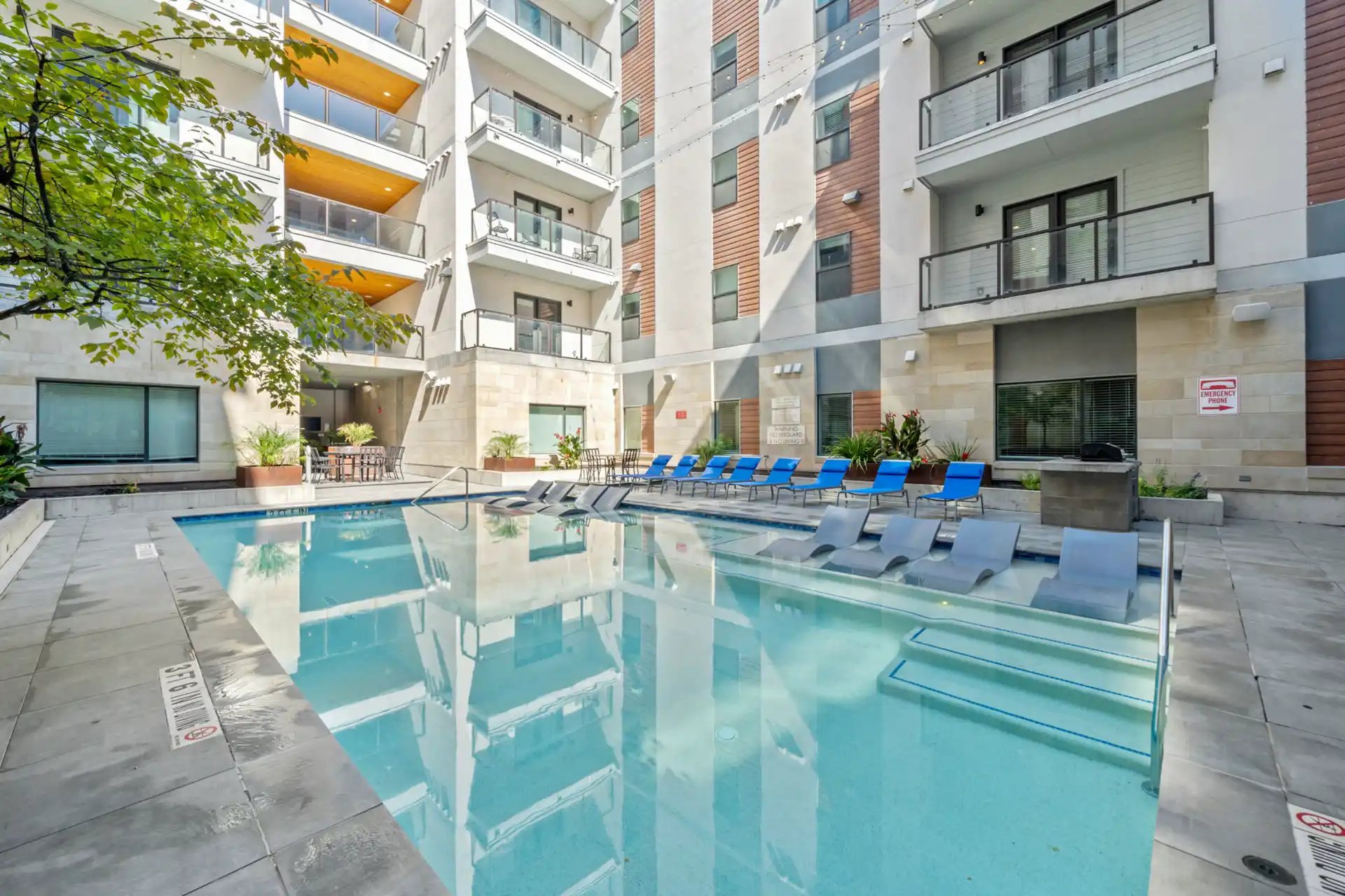 Pool with lounge chairs and building exterior. at The Villas at San Gabriel in Austin Student Accommodation
