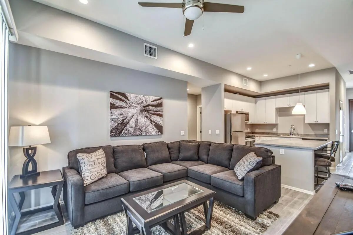 Grey sectional sofa coffee table kitchen living room at The Bradford in Tempe Student Accommodation