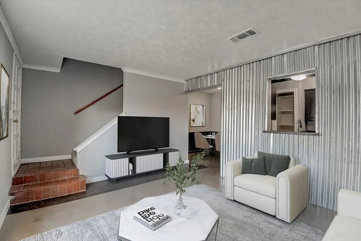 Sofa and TV in living room with dining area visible Living room at Across The Street Apartments in Denton Student Accommodation