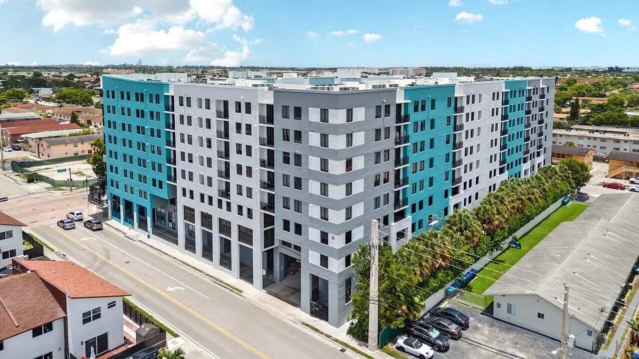 Modern apartment building with blue and gray sections exterior at 4th Street Commons Apartments in Miami Student Accommodation
