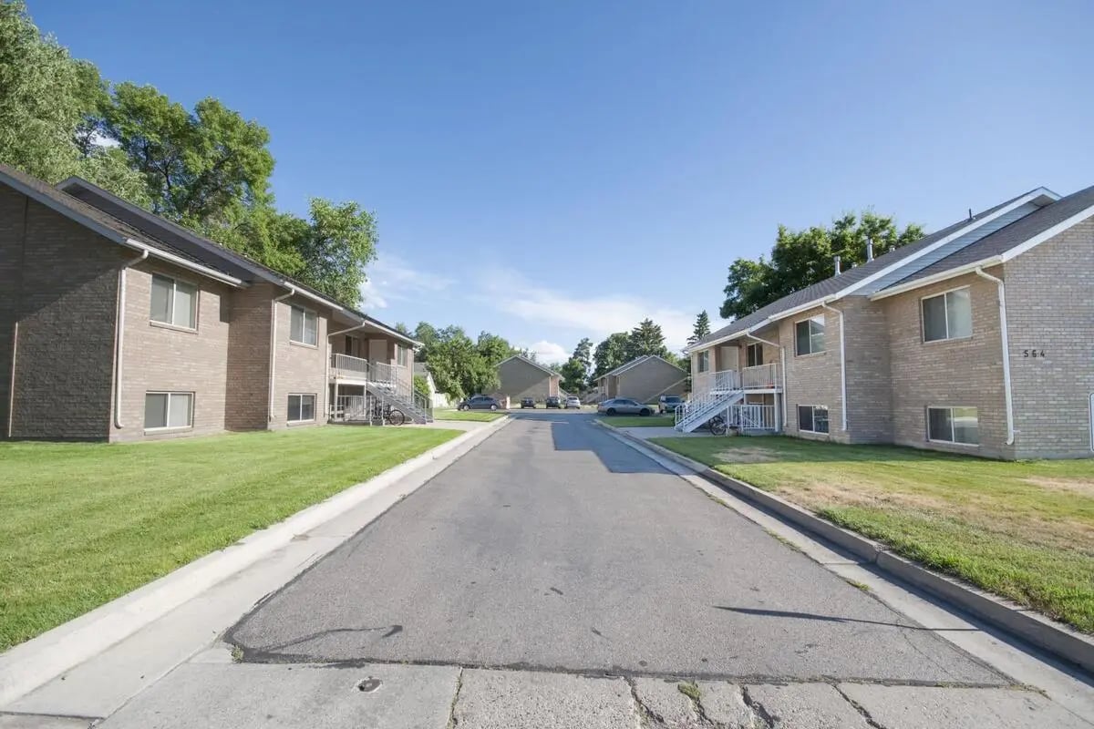 Apartment buildings with stairs and grassy lawns exterior at Afton Apartments in Logan Student Accommodation
