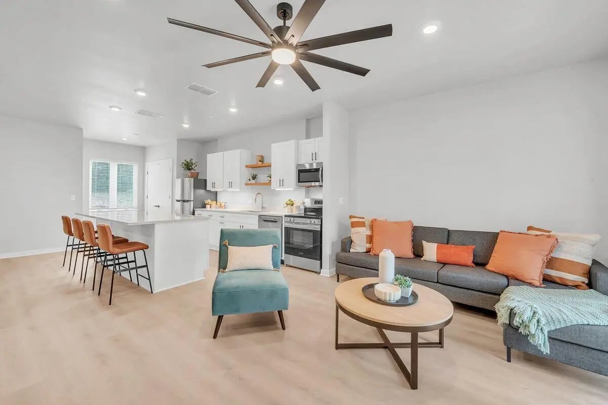 Sofa armchair coffee table island kitchen living room at The Timbers in San Marcos Student Accommodation