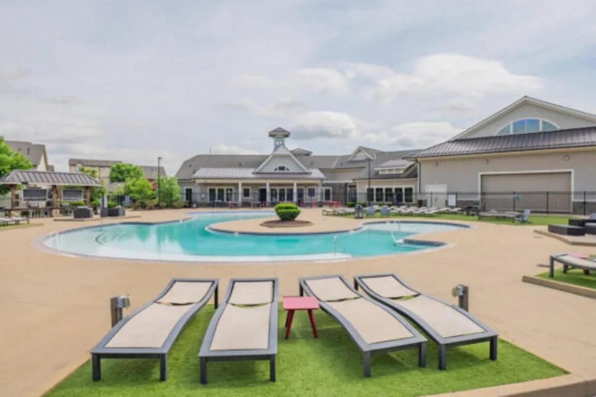 Four loungers by pool building exterior at Brexx at Louisville in Louisville Student Accommodation