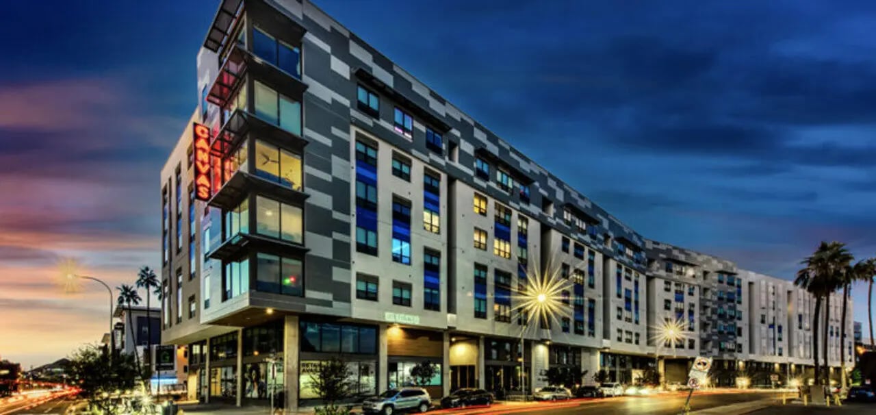 Modern building with neon sign exterior at Canvas in Tempe Student Accommodation