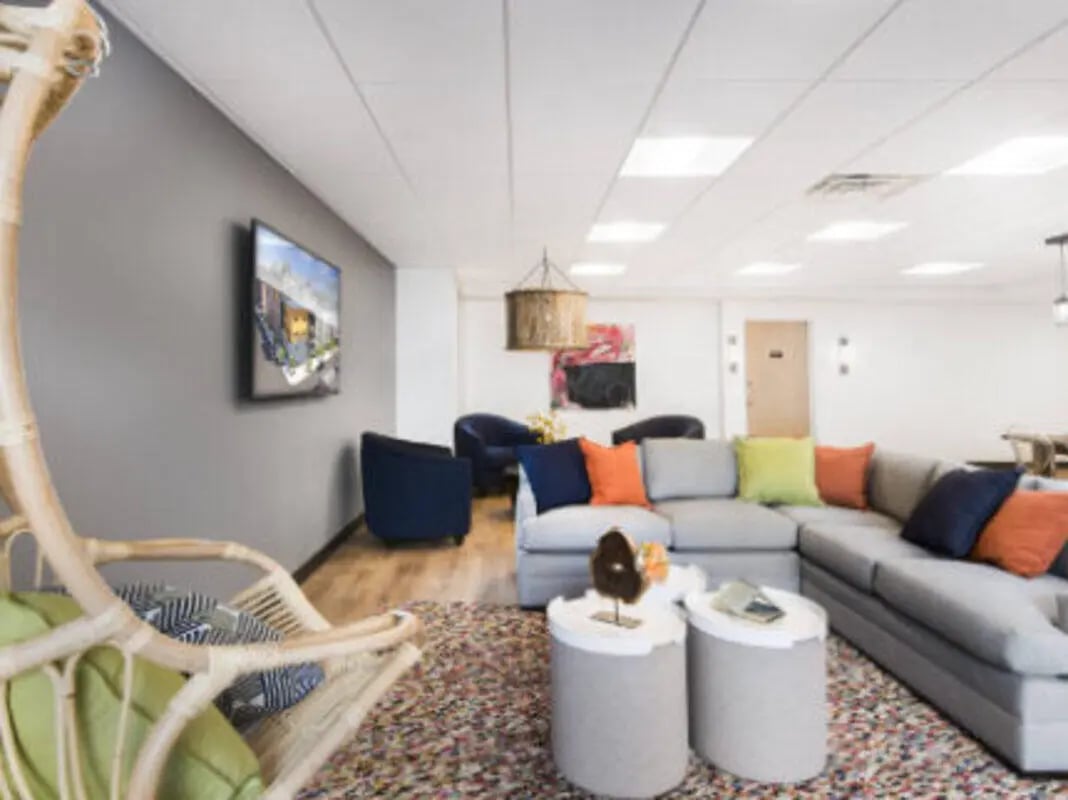 Lounge with sectional sofa hanging chair living room at UCity Flats in Philadelphia Student Accommodation