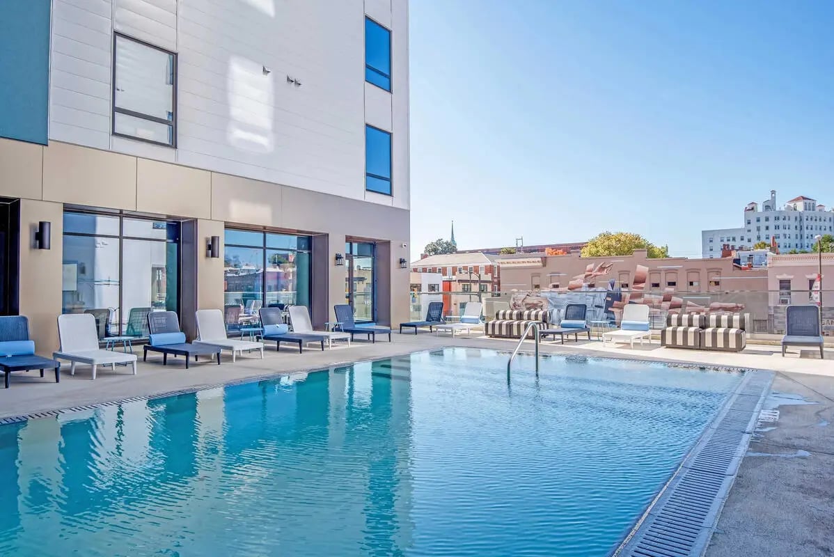 Lounge chairs pool building exterior at Ascend RVA in Richmond Student Accommodation