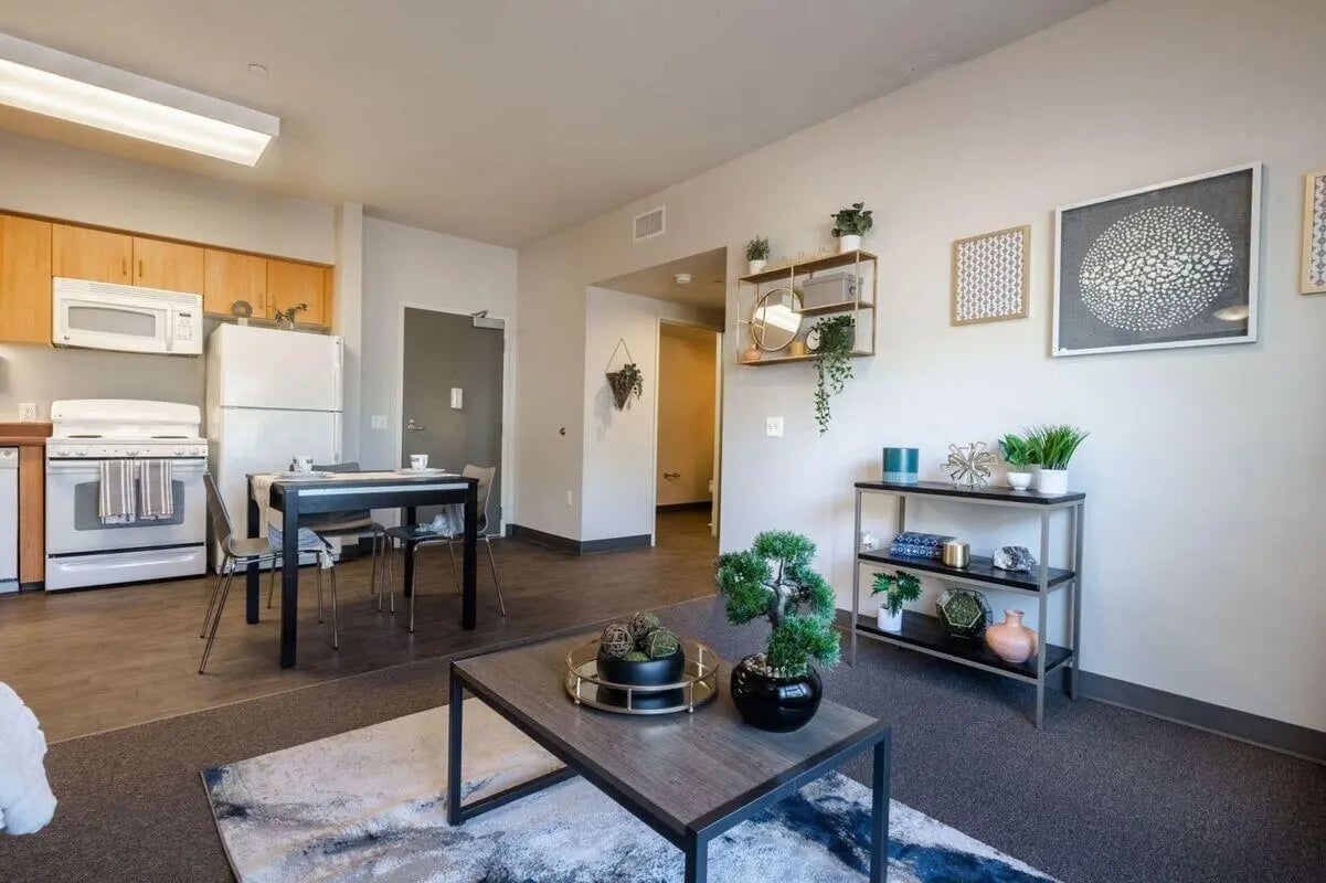 Kitchen dining area with table and living area Living Room at Claremont Collegiate Apartments