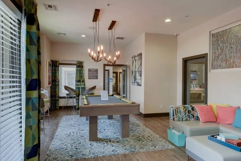 Pool table lounge area with sofa and seating. at The U Apartments in Davis Student Accommodation