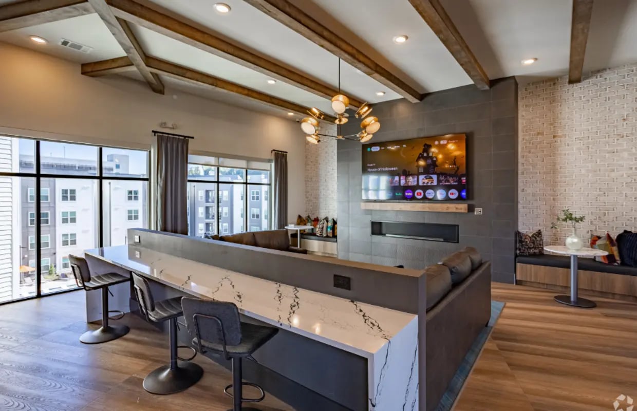 Island counter with stools and large TV living room at The Davy in Knoxville Student Accommodation