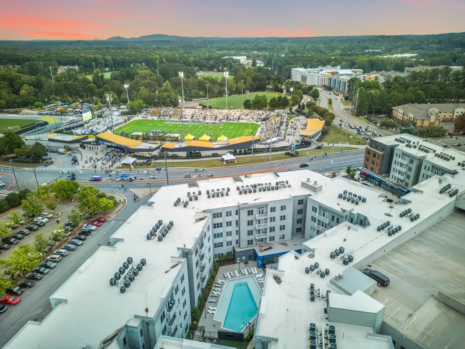 Rooftops with air conditioning units and pool exterior at Bixby Kennesaw in Kennesaw Student Accommodation