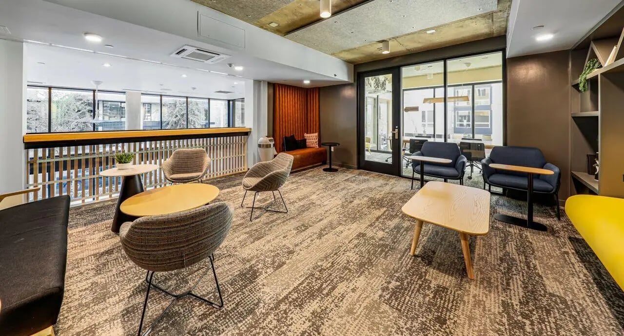 Seating area with modern chairs and tables communal lounge at Theory U District in Seattle Student Accommodation