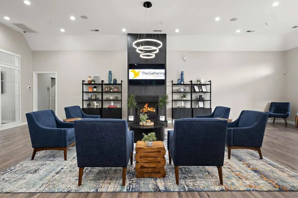 Blue chairs fireplace TV shelves rug living room at The Gathering in Salisbury Student Accommodation
