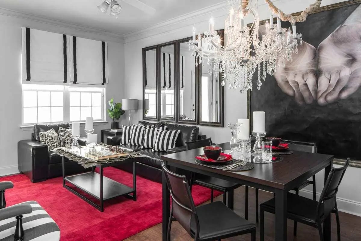 Leather sofa dining table and red rug living room at The George in Statesboro Student Accommodation