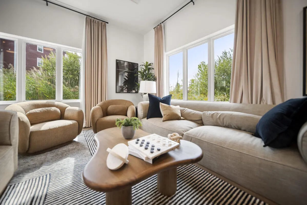 Modern living room with neutral sofa and chairs at Block20