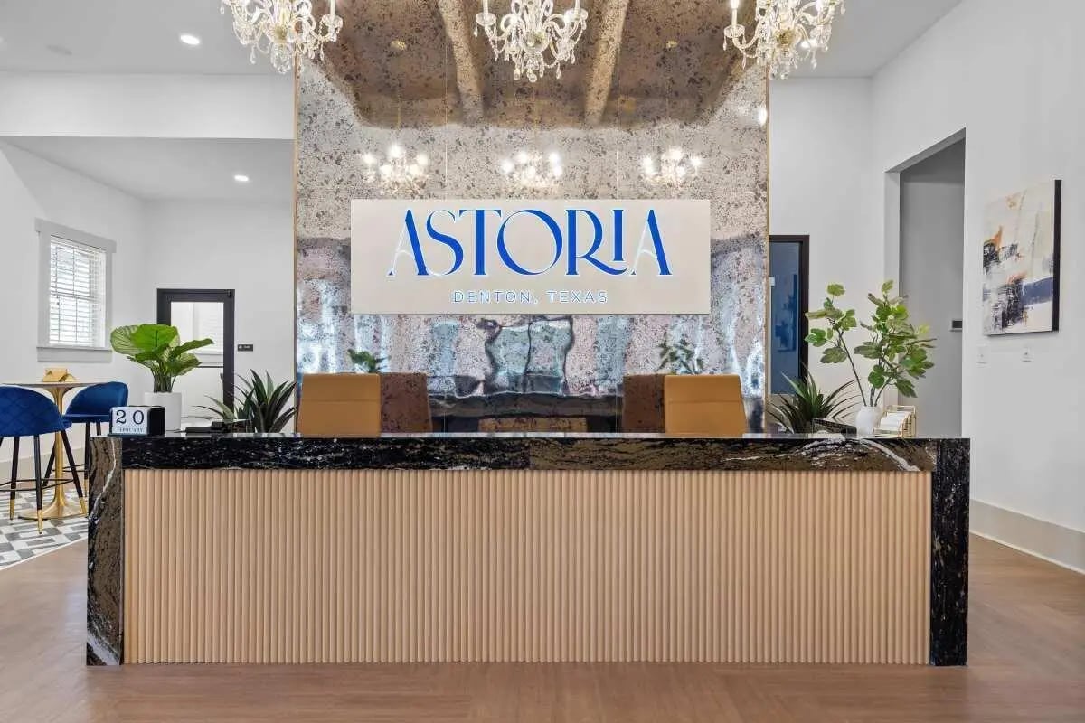 Reception desk plants and Astoria logo lobby at Astoria in Denton Student Accommodation