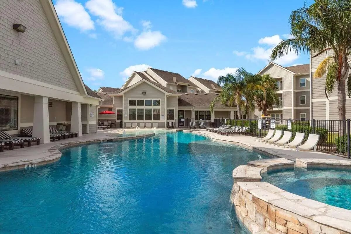 Large swimming pool with lounge chairs exterior at Campus Quarters in Corpus Christi Student Accommodation