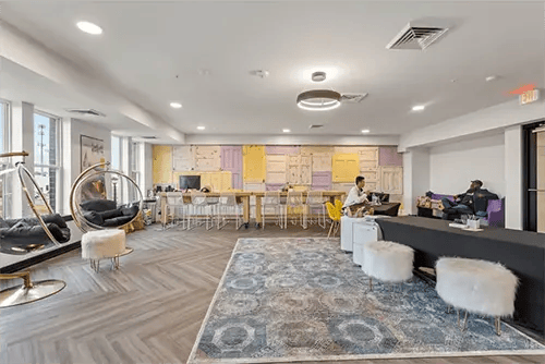 Hanging chairs communal tables lounge area living room at The Jolly Roger in Greenville Student Accommodation
