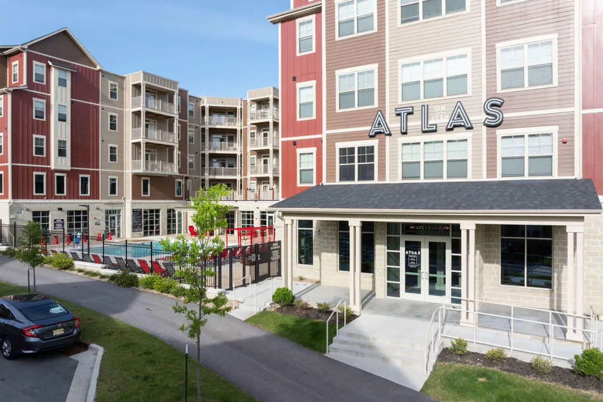 Apartment complex pool and entrance exterior at Atlas on 17th in Bloomington Student Accommodation