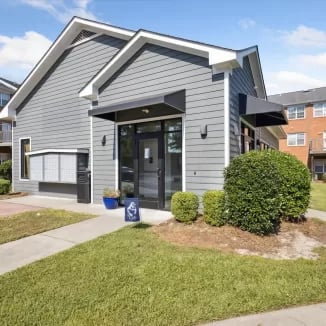 Grey building entrance with awnings landscaping exterior at Eighteen18 at Southern in Statesboro Student Accommodation
