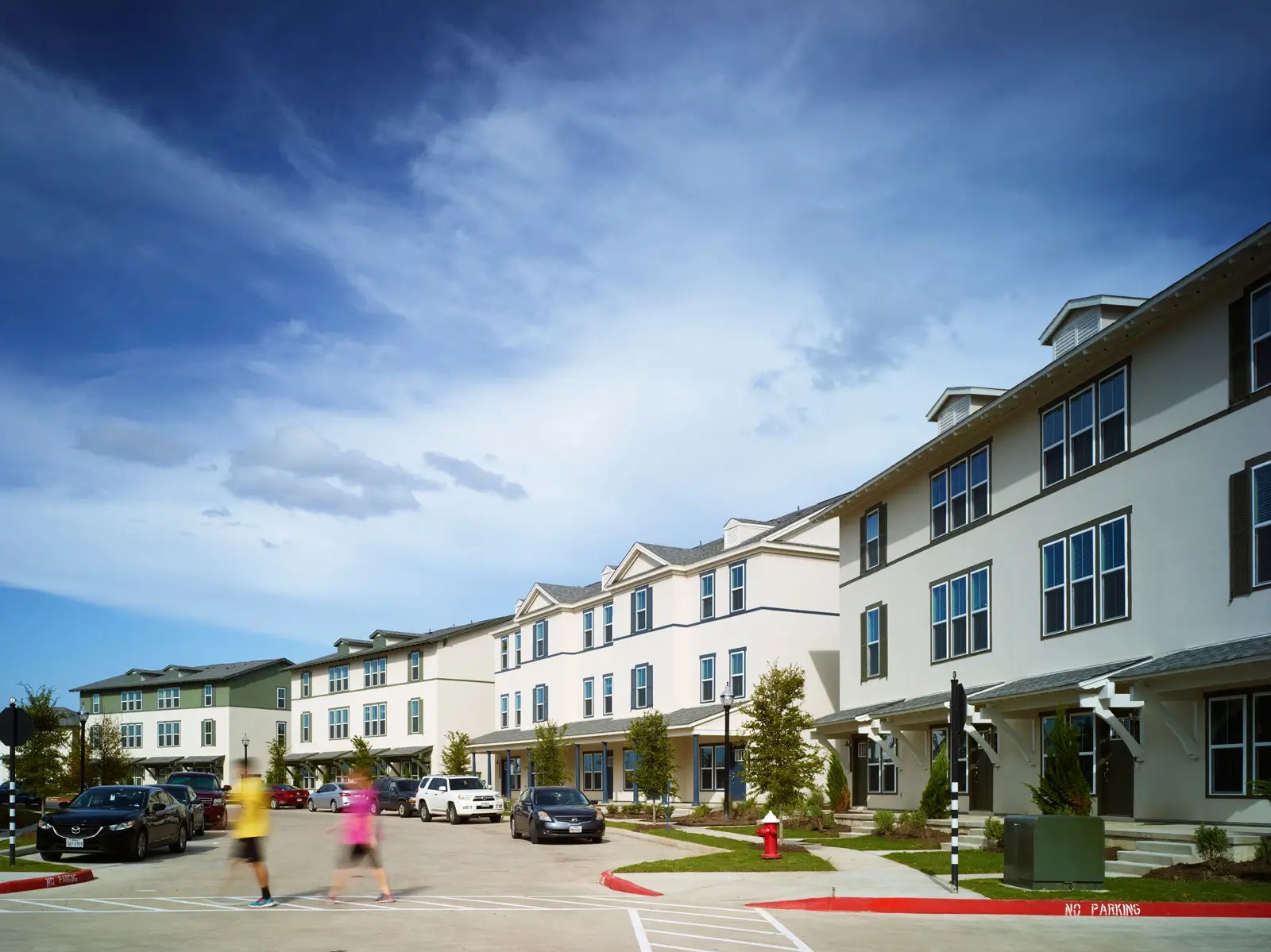 Townhouses with cars parked outside exterior at The Junction at College Station in College Station Student Accommodation