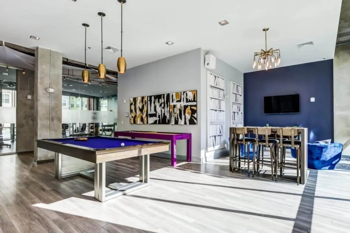 Pool tables bar seating and abstract art lounge at The Boundary At West End in Greenville Student Accommodation