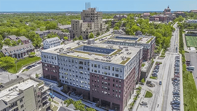 Modern apartment buildings with parking lot exterior at Here Kansas in Lawrence Student Accommodation