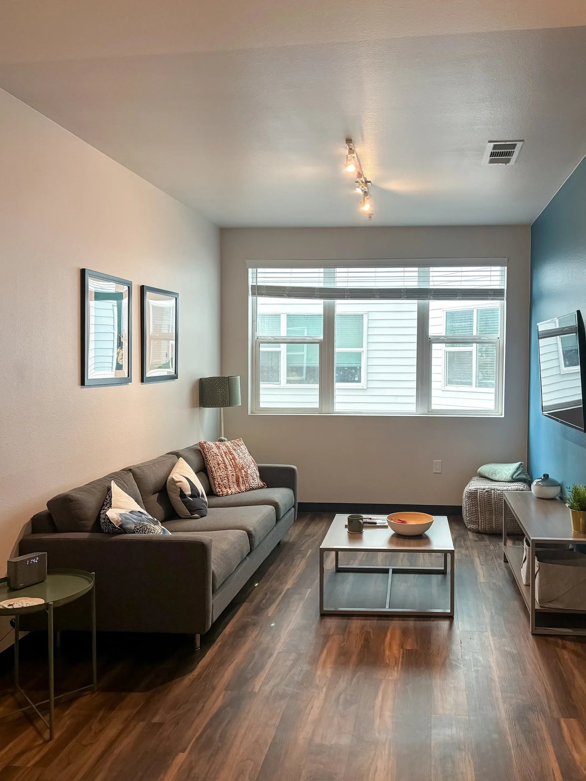 Sofa coffee table artwork window and TV living room at Fifteen51 in Reno Student Accommodation