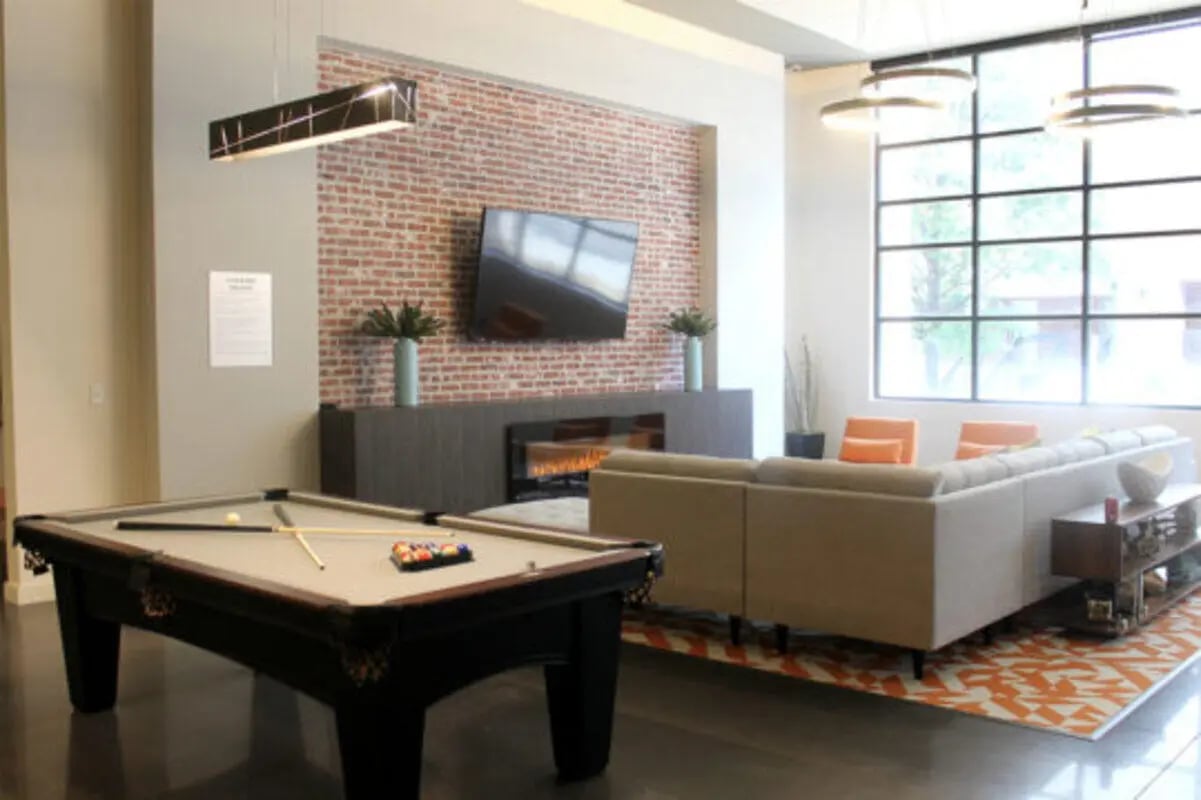 Pool table sofa fireplace lounge area living room at The Knox Apartments in Knoxville Student Accommodation