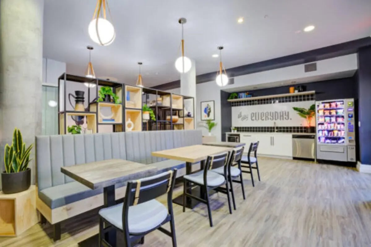 Seating tables and vending machine communal area at The District on 5th in Tucson Student Accommodation