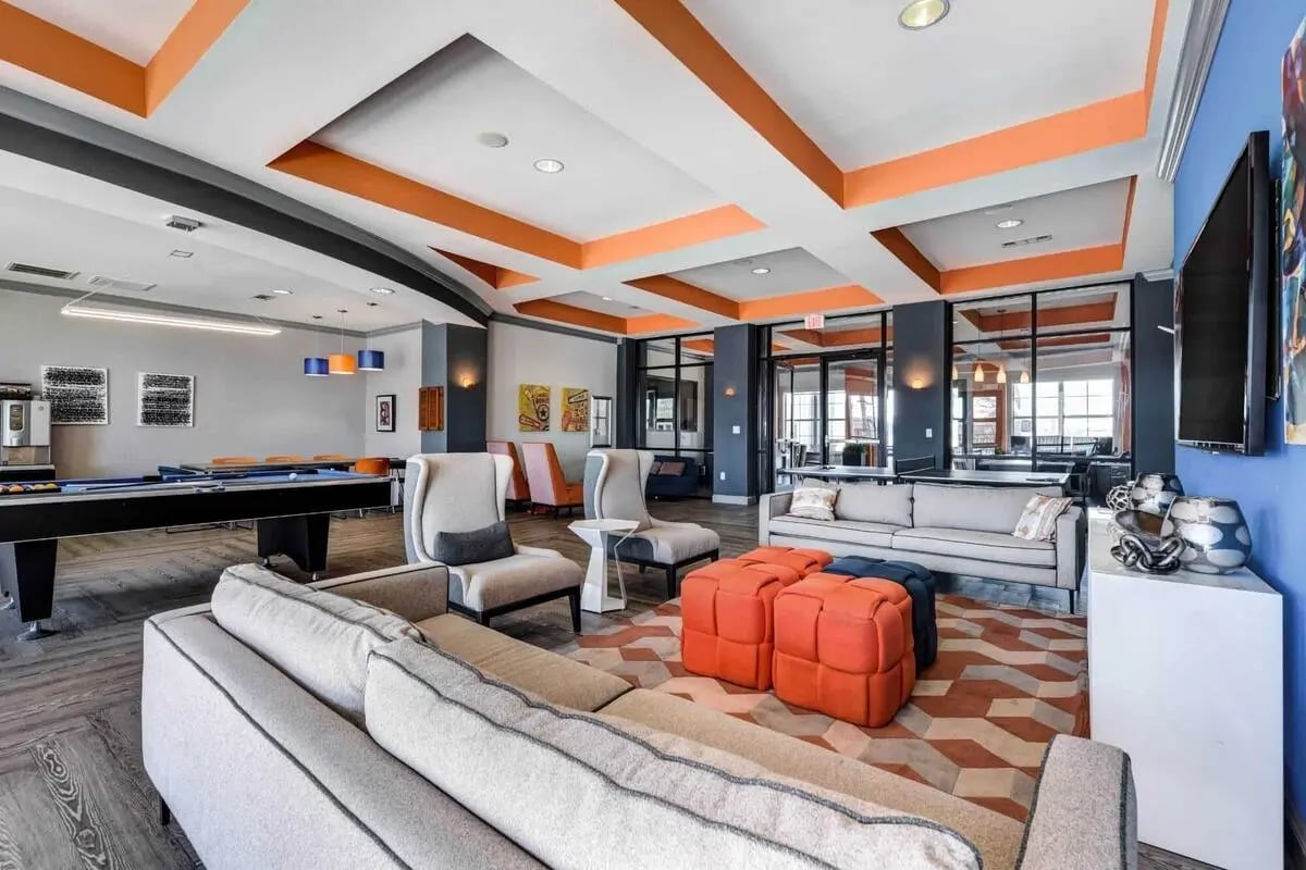 Billiard table sofas chairs and ottomans lounge area at High View in San Antonio Student Accommodation