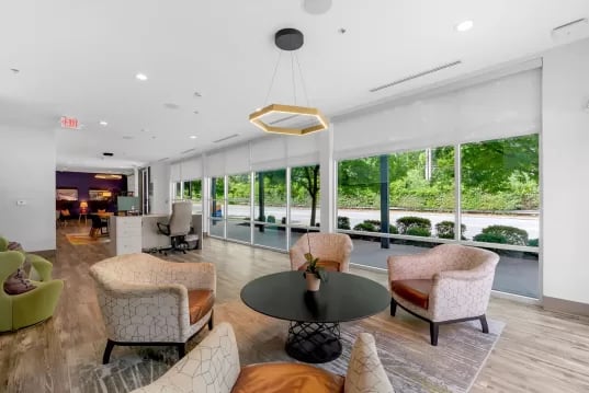 Armchairs table reception desk desk chairs living room at GrandMarc Clemson in Clemson Student Accommodation