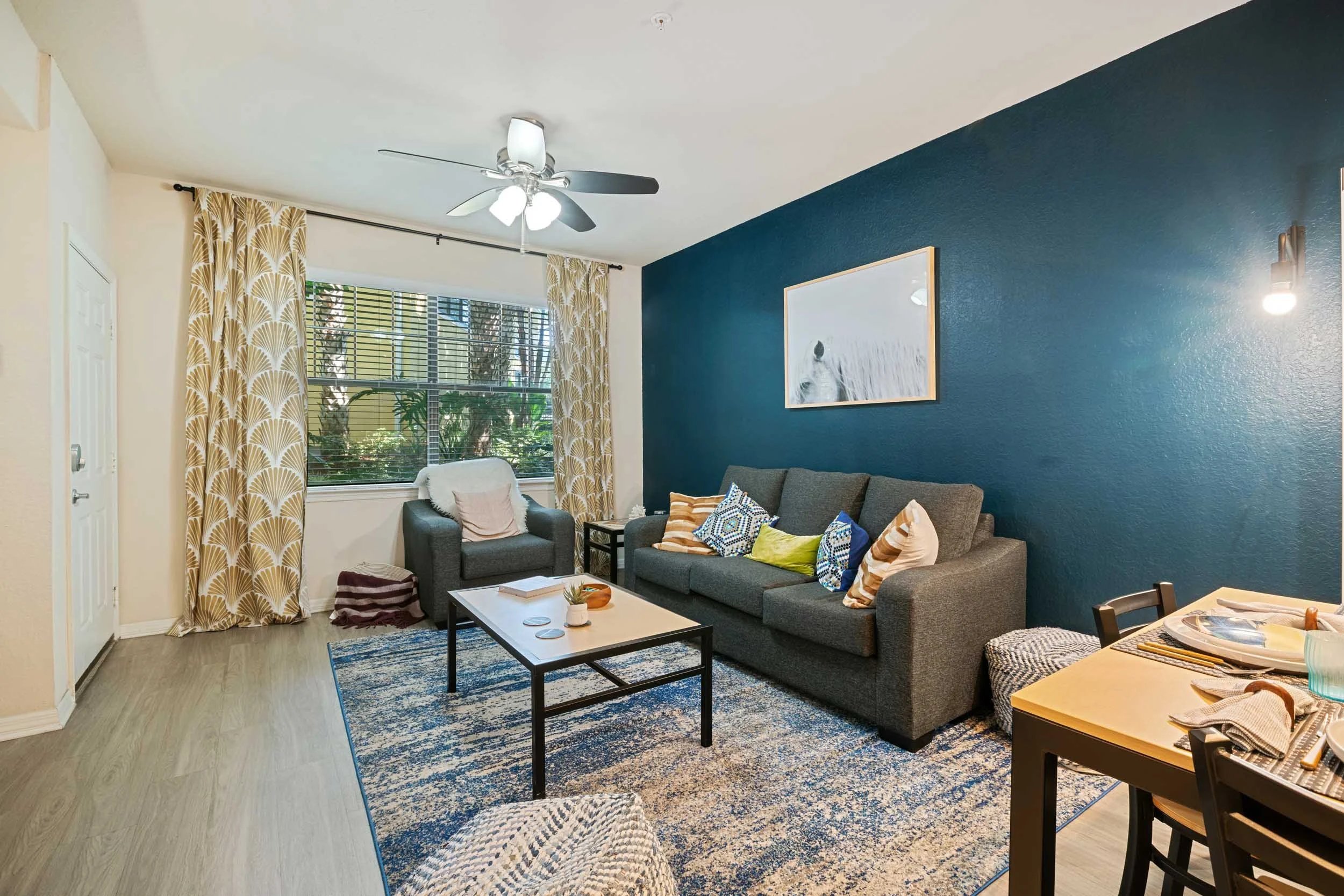 Sofa armchair coffee table and dining table living room at The Verge in Orlando Student Accommodation