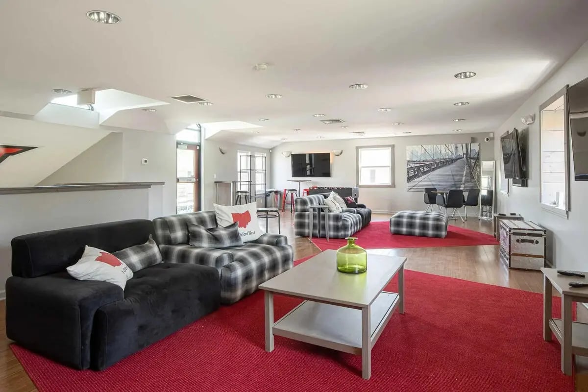 Sofas tables and ottomans in lounge living room at Oxford West Apartments in Oxford Student Accommodation