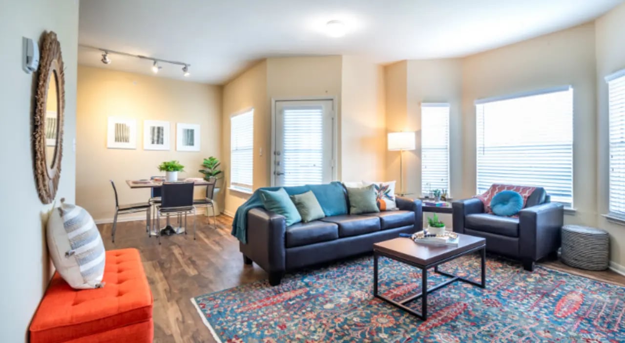 Leather couch chairs coffee table dining set living room at The Cottages at Hillside Ranch in San Marcos Student Accommodation